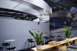 Close-up of the Trimble booth with seating area, greenery, and a clean design for consultation sessions.