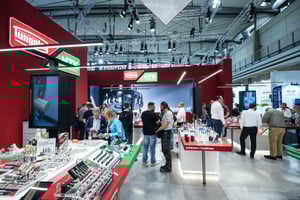 Close-up of the Tungaloy section at the IMC Group booth with consultation tables and displayed tooling solutions.