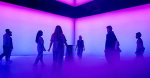 Caption of the Dubai Future Foundation Event showing people in a blue-and-violet-lit room with mist on the ground.