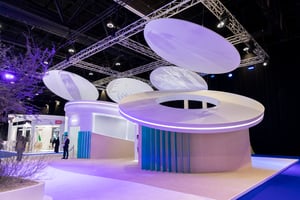 Architectural details of the UAE Pavilion with large white rings and a modern booth layout.