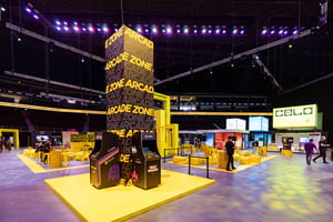 Event zone labeled Arcade Zone with interactive displays and yellow themed decor
