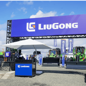 Entrance to the LiuGong stand at Steinexpo 2026, featuring a large blue banner and a small reception desk.
