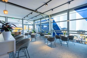 Indoor seating area within LiuGong’s booth with modern chairs and tables, creating a welcoming space for discussions.