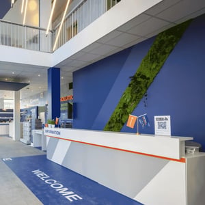 Reception area of a Liugong showroom featuring brand presentation for customers in the building, infrastructure and construction sectors.
