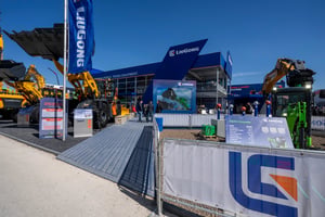 Another outdoor perspective of LiuGong’s booth showcasing construction equipment and visitors exploring the stand.