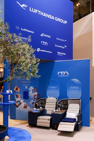 Detail view of Lufthansa Group's exhibition booth at ITB 2026 with airline seats for guests to try.