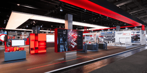 Overall view of the SEW-EURODRIVE booth with a distinctive red frame, product displays, and interactive information areas.
