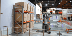 Section of the STILL booth showcasing racking systems and product presentations for warehouse and intralogistics solutions.