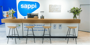 The reception desk of Sappi's exhibition booth with the text