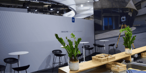 Close-up of the Trimble booth with seating area, greenery, and a clean design for consultation sessions.