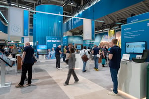 Several people attending Xylem's exhibition booth inbetween display walls.