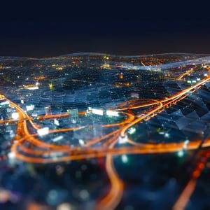 Yellow-lit highways leading through bluely-lit buildings and skyscrapers, repesenting the interconnectin brands bluepool and ET GLOBAL.