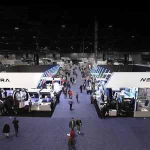 NEURA Exhibition stand with futuristic design elements, robotics machines and surrounding people.