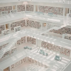 The inner look of a huge white library with rows of books. This image represents the knowledge that was trandsferred from KECK to ET GLOBAL.