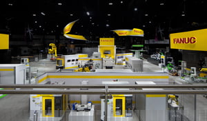 Immersive exhibition booth from FANUC with big yellow highlights at the IMTS 2024