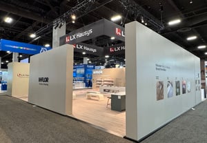 LX Hausys exhibition booth with warm lights and beige panels, clean and modern vibe