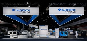 Sumitomo's bright white and blue exhibition booth with big machines at NPE 2024